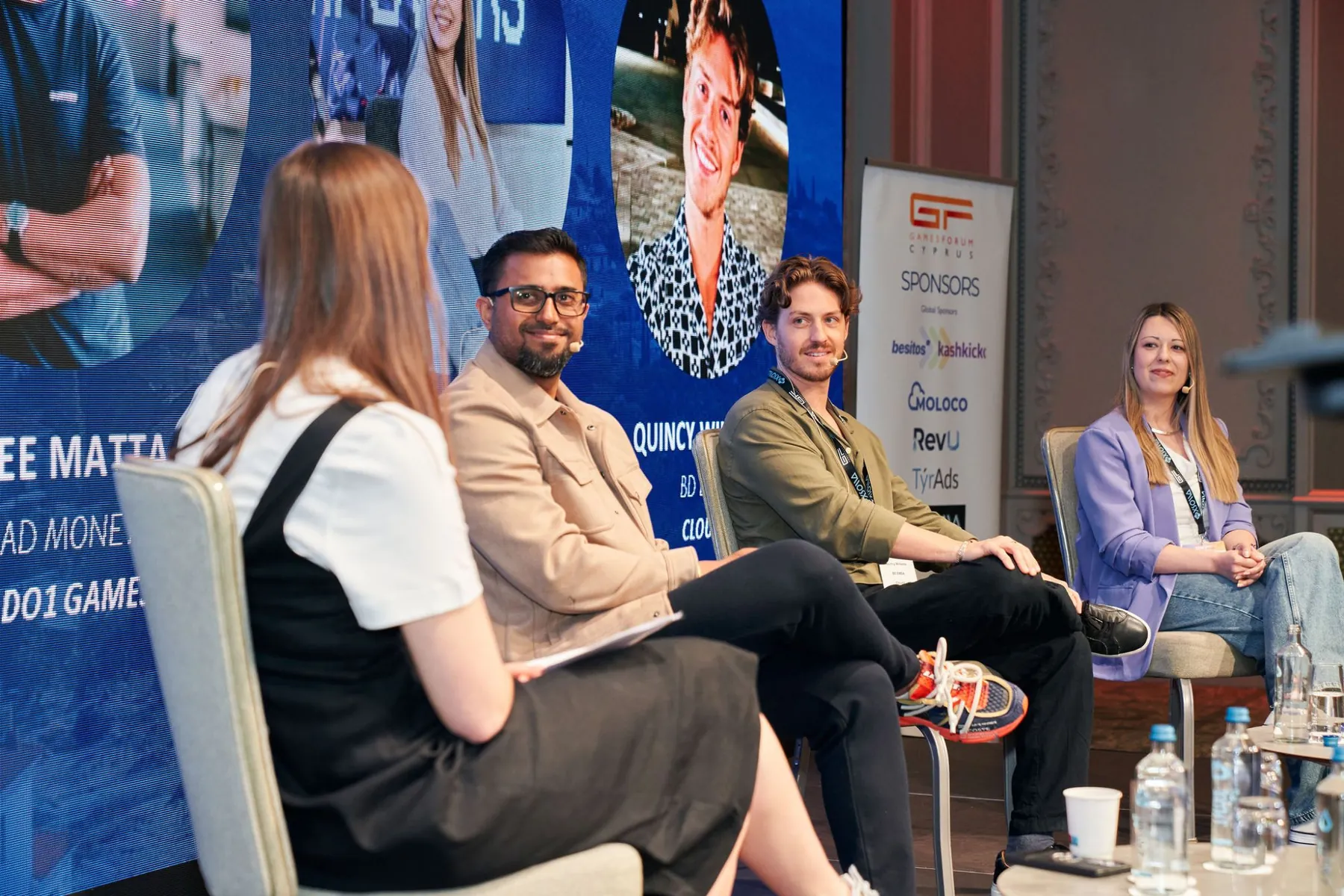 Dhee smiling on a four-person panel at Gamesforum Cyprus.